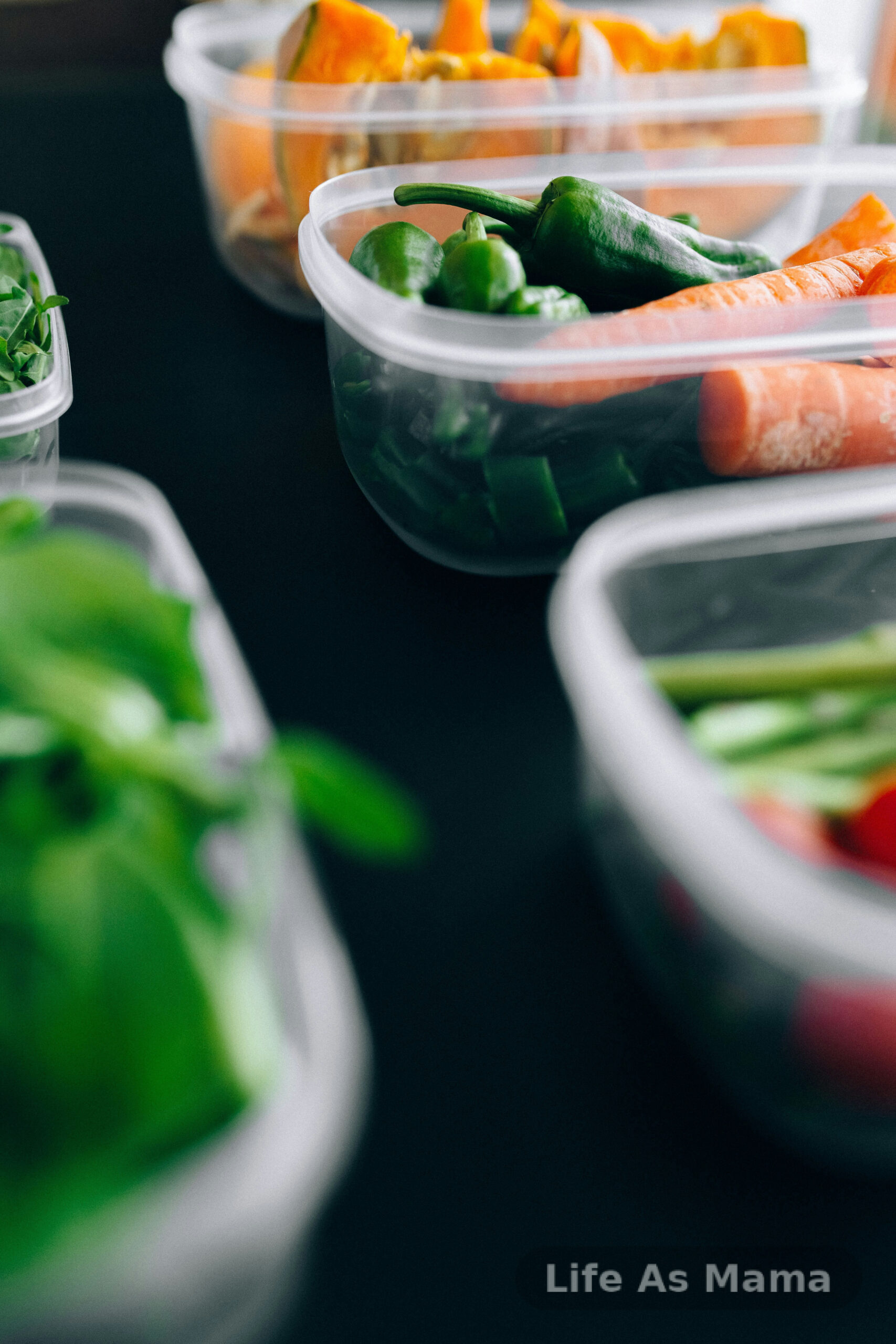 Fresh vegetables being chopped and sorted into bowls during a summer meal prep session