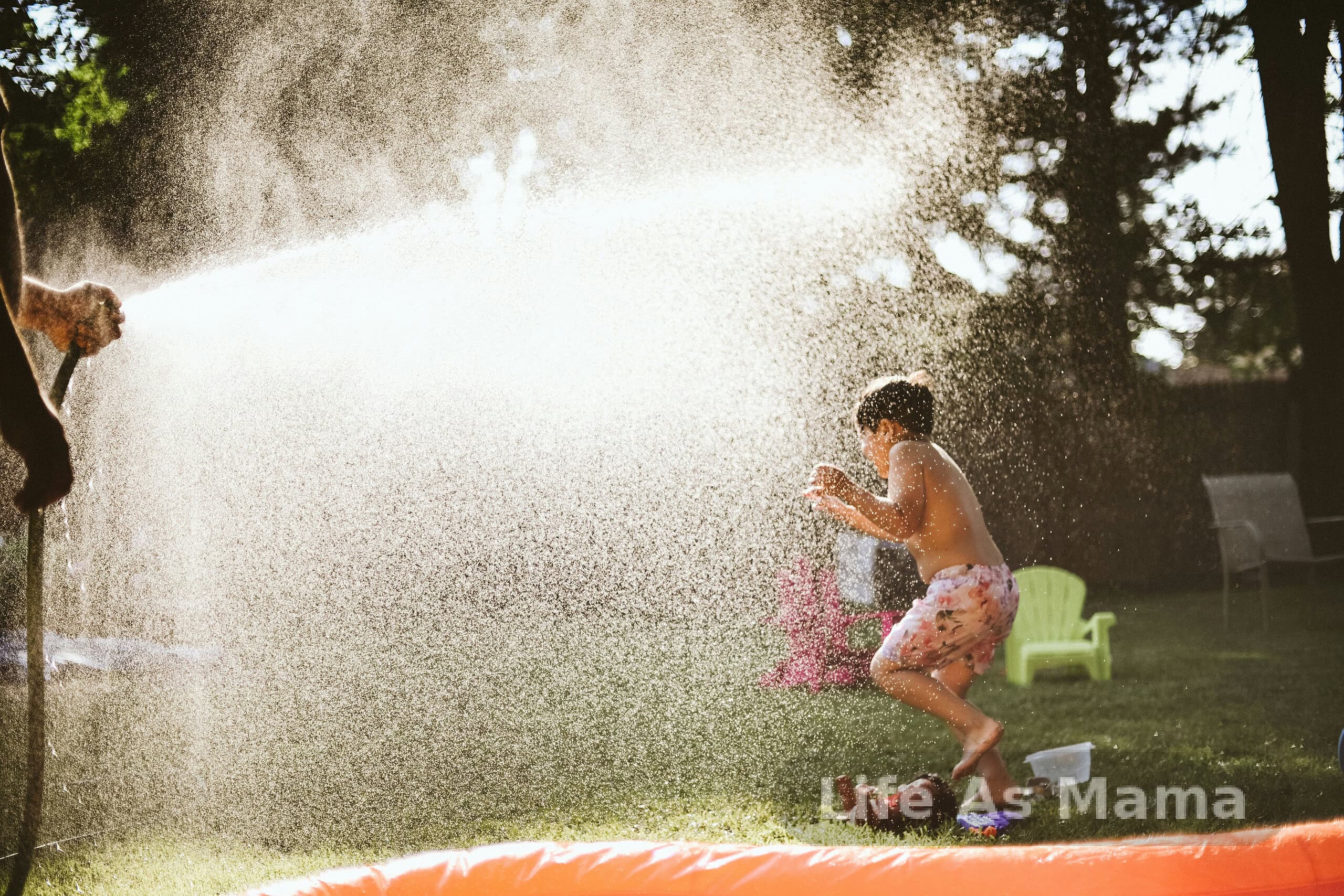 Kids enjoying water activities outside on a bright summer day
