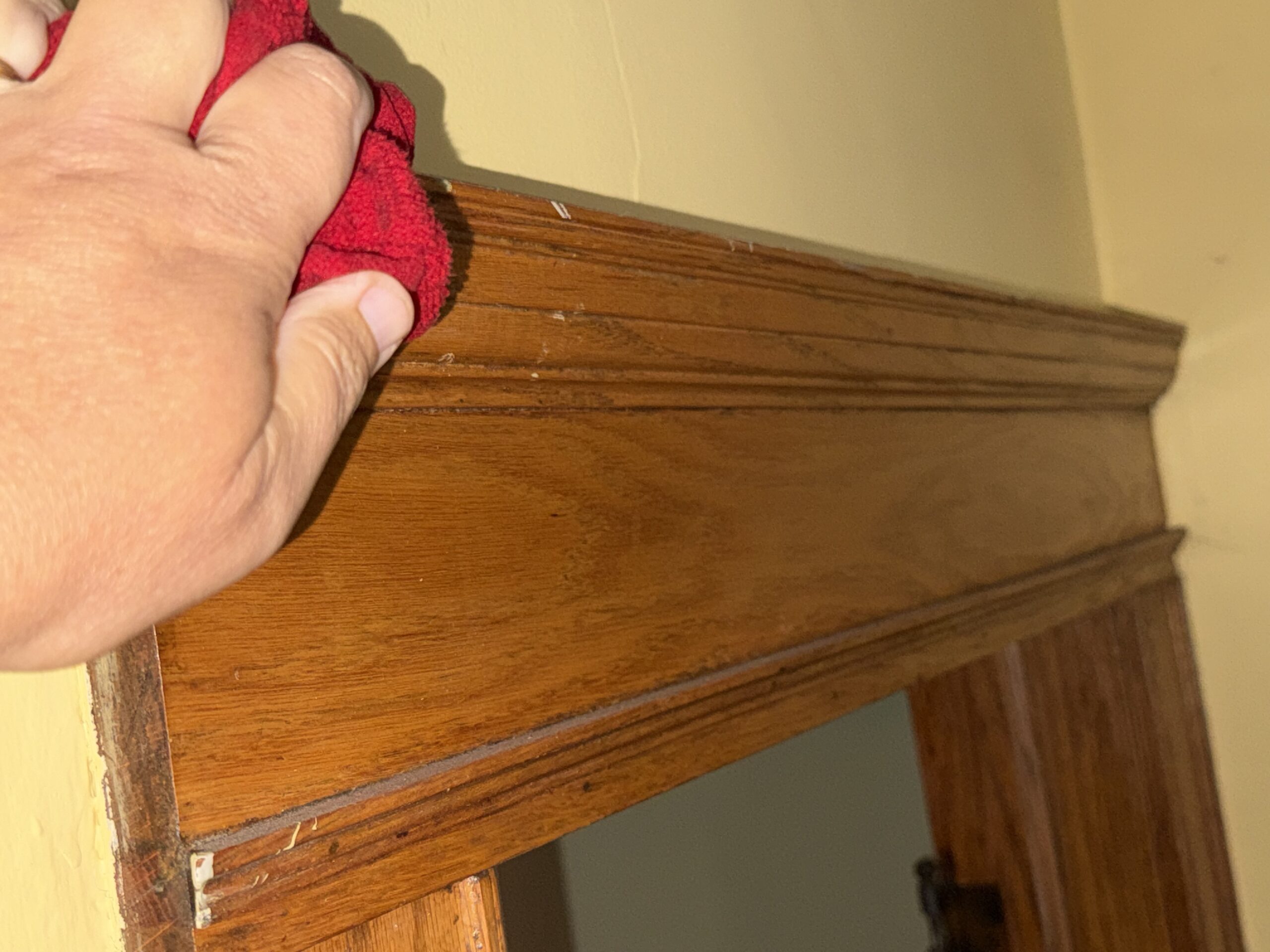 wiping down baseboards during a house deep cleaning